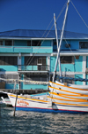 Belize City, Belize: mouth of Haulover Creek - house and boat Viayendi loaded with canoes - photo by M.Torres