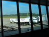 Bandar Seri Begawan, Brunei Darussalam: Brunei International Airport - Royal Brunei Airlines Airbus A319-132 V8-RBR being serviced in the airport apron, seen from inside the terminal - photo by M.Torres