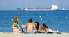 La Pineda, Vila-seca, Costa Dorada, Tarragona, Catalonia: two couples on the beach with a freighter in the background - photo by B.Henry