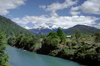 Los Lagos Region, Chile: river along the Camino Austral, a dirt road, but the main route in Northern Patagonia - snow covered mountains in the background - photo by C.Lovell