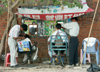 China - Hainan Island: outdoor haircut - low-overhead barbershop  (photo by G.Friedman)