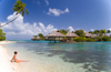 Papetoai, Moorea, French Polynesia: InterContinental Hotel - coconut tree over a perfect white sand beach with a young woman in the foreground - tropical resort - photo by D.Smith