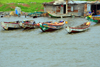 Banjul, The Gambia: traditional wooden fishing boats and fishermen huts made of corrugated metal - photo by M.Torres