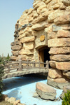 Erbil / Hewler, Kurdistan, Iraq: Shanadar Park - bridge over a dry moat, leading to a fake cave - evoques Shanidar Cave, an archaeological site in the Zagros Mountains that yielded the first adult Neanderthal skeletons in Iraq - photo by M.Torres