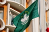 Macau, China: Macanese flag - green flag of the Macau SAR with a lotus flower above the Governador Nobre de Carvalho Bridge - photo by M.Torres