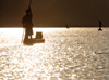 Antsalova district, Melaky region, Mahajanga province, Madagascar: Manambolo River - men in canoes - sunrise light reflected on the water - photo by M.Torres