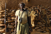 Bandiagara Escarpment, Dogon country, Mopti region, Mali: hunter with his weapon, pipe and trophies - photo by J.Pemberton