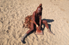 Namibia: Himba Woman grinding ochre, Skeleton Coast, Kunene region - photo by B.Cain