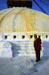 Kathmandu valley, Nepal: Bodhnath temple - monk at the central stupa - photo by W.Allgwer