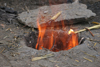 Kodar Bala, Siran Valley, NWFP, Pakistan: fire coming out of a tandoor - traditional oven for baking bread - cylindrical clay oven - tandur - tandoori - photo by R.Zafar