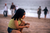 Karachi, Sindh, Pakistan: something catches the eye - s girl looking out towards the Arabian sea - photo by R.Zafar