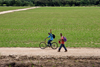 Aguadulce, Cocle province, Panama: plantation workers wave and smile for the camera - grass field - photo by H.Olarte