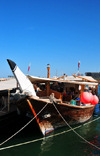 Doha, Qatar: dhow with large red buoys - traditional sailing vessels with lateen sails used in the Persian Gulf, Red Sea and Indian Ocean region, now often motorized and without sails - Dhow harbour - photo by M.Torres