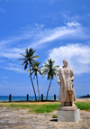 So Tom, So Tom and Prncipe / STP: statue of Joo de Santarm and coconut trees - seafarer the discovered the island for Portuguese king D. Afonso V, on behalf of Ferno Gomes da Mina - fort of Saint Sebastian / esttua de Joo de Santarm, explorador que descobruiu a ilha para o rei D. Afonso V, ao servio de Ferno Gomes da Mina - Forte de So Sebastio - photo by M.Torres