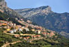 Baunei, Ogliastra province, Sardinia / Sardegna / Sardigna: the town, the SS125 road and the sandstone cliffs - photo by M.Torres