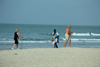 Cap Skirring, Oussouye, Basse Casamance (Ziguinchor), Senegal: man Walking on the beach to sell necklaces and an old couple walking, everyday life / Homem caminhando na praia para vender colares e um casal a passear, vida quotidiana - photo by R.V.Lopes