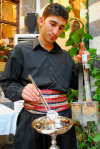 Damascus, Syria: changing the coal of a nargeela - the 'Oriental' - Syrian-Armenian restaurant - old town - photographer: M.Torres