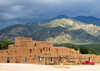 Pueblo de Taos, New Mexico, USA: multi-storied residential complex of reddish-brown adobe against the Sangre de Cristo mountains - North Pueblo - photo by M.Torres