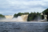 161 Venezuela - Bolivar - Canaima National Park - a small boat approaches Salto Golondrina, Canaima lagoon - UNESCO world heritage - photo by A. Ferrari